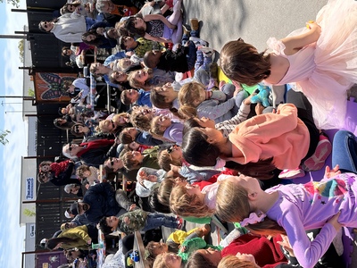 Several children sitting on the floor watching a performance